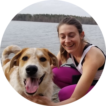 Claire Bell, woman with brown hair with dog in front of lake
