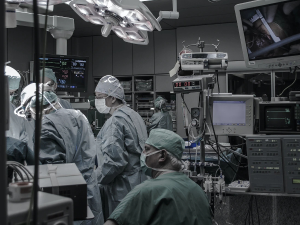 dimly lit operating room with surgeons